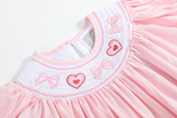 Pink Hearts & Bows Smocked Bishop Dress for babies, shown from angle 3, featuring a charming design and soft fabric.
