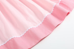 Pink Hearts & Bows Smocked Bishop Dress for babies, angle view showcasing adorable design and details.