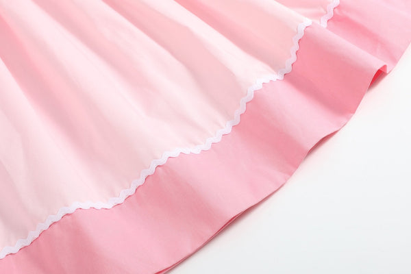 Pink Hearts & Bows Smocked Bishop Dress for babies, angle view showcasing adorable design and details.