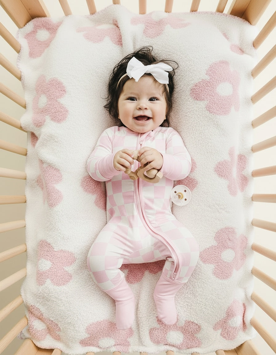 Soft pink Daisy Fuzzy Blanket for babies, perfect for cuddling and keeping warm.