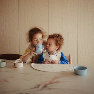 Silicone training cup with straw at a 40-degree angle, perfect for toddlers learning to drink independently.