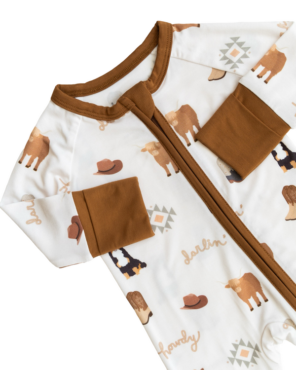 "Bedtime Buckaroo Zipper Lounger for babies in cozy loungewear, shown from angle 4."
