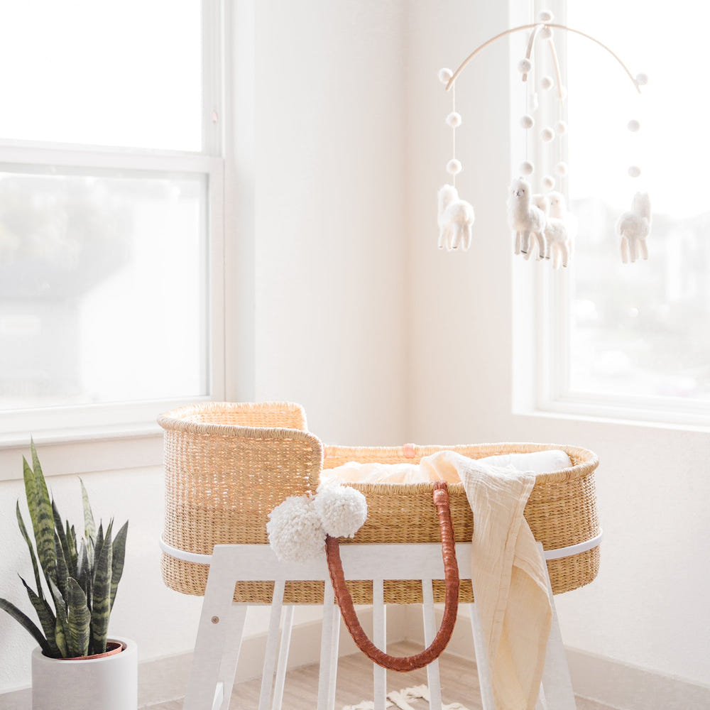 Modern white rocking Moses bassinet stand with brake, perfect for safe and stylish baby sleeping.