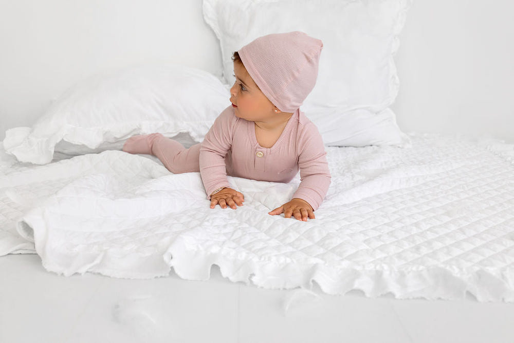 Blush Henley Footie for babies - cozy zip pajamas for comfort and style.