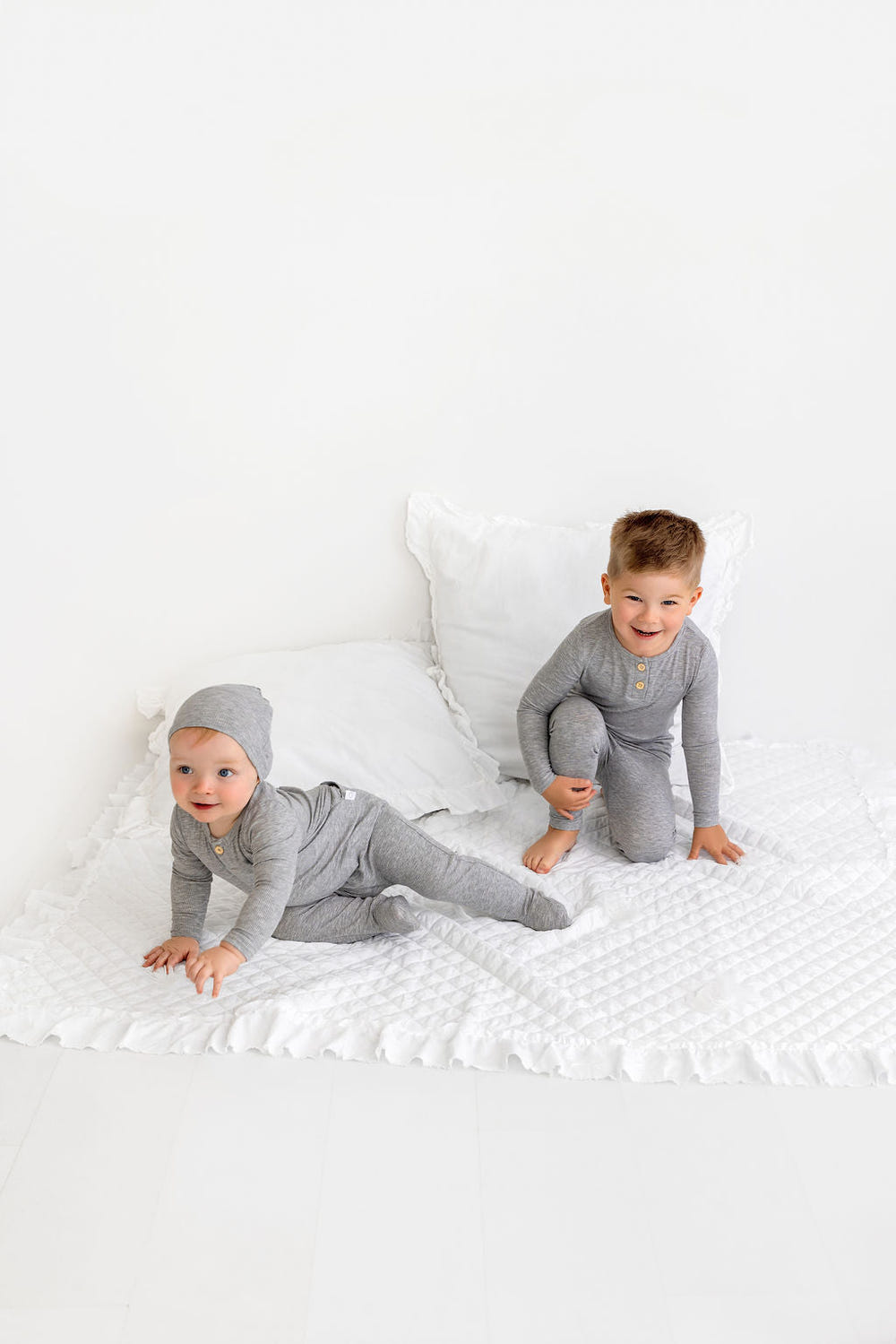 Grey Henley Footie for babies, cozy zip pajamas for comfort and style. Perfect for sleep and play.