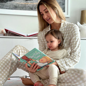 Women's long sleeve gingham pajama set for babies, perfect for cozy sleep and bedtime comfort.