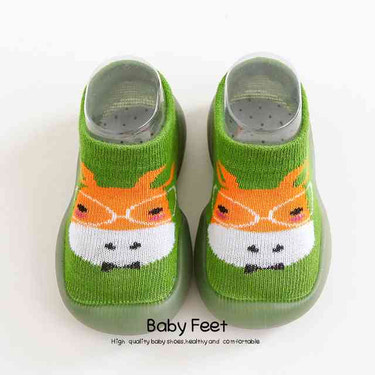Green cow animal sock shoes for babies - cute and comfortable footwear for little ones.