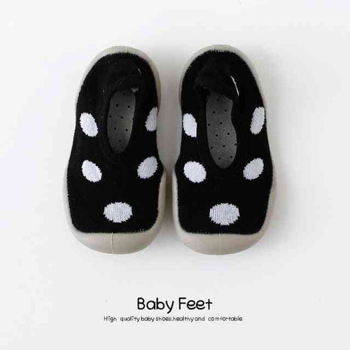 Black baby sock shoes with white spots, perfect for little feet. Stylish and comfortable footwear for infants.