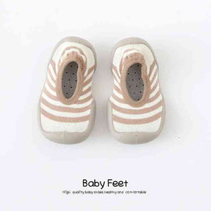 Tan lines baby sock shoes, perfect for little feet. Stylish and comfortable footwear for infants.