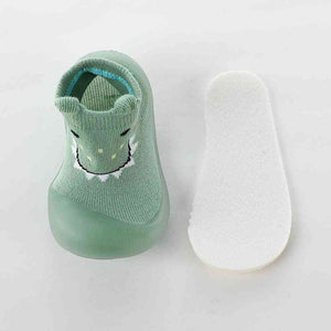 Green monster-themed baby sock shoes, perfect for tiny feet and playful adventures.