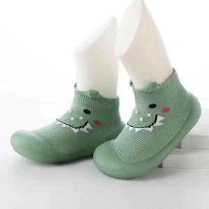Baby Pet Sock Shoes in Monster Green, angle view, perfect for tiny feet and playful adventures.