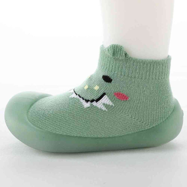 Green monster-themed baby sock shoes, perfect for tiny feet and playful adventures.