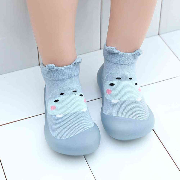 Blue monster-themed baby sock shoes, perfect for tiny feet. Angle view showcasing design and comfort.