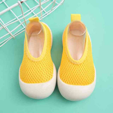 Light yellow baby first walkers, perfect shoes for infants learning to walk.