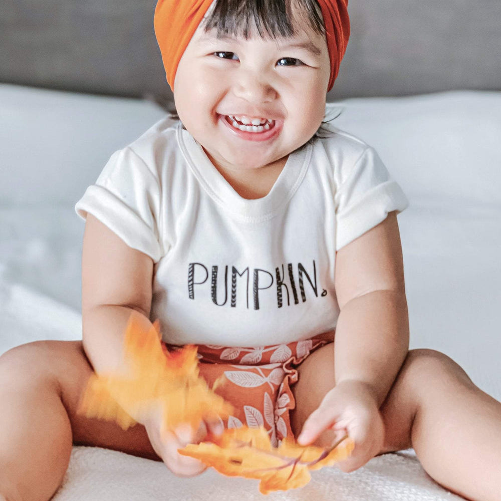 Pumpkin graphic short sleeve bodysuit for babies, perfect for autumn outfits and cozy comfort.