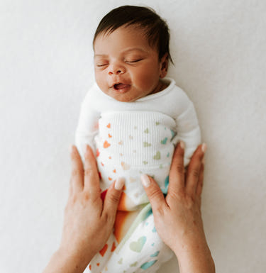 Rainbow Swaddle Sleep Sack for babies, soft and cozy, perfect for peaceful sleep and comfort.