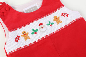 Red Velvet Christmas Smocked Overalls for babies, showcasing festive design and cozy fabric from an angled view.