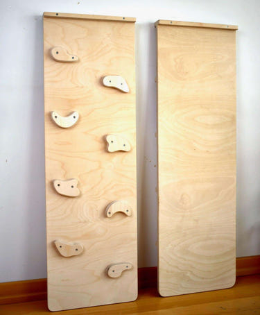 Reversible rockwall climbing and sliding ramp for babies, promoting active play and motor skills development.