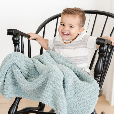 Ribbed Bamboni® toddler blankets in soft colors, perfect for cozy bedding and sleep for little ones.