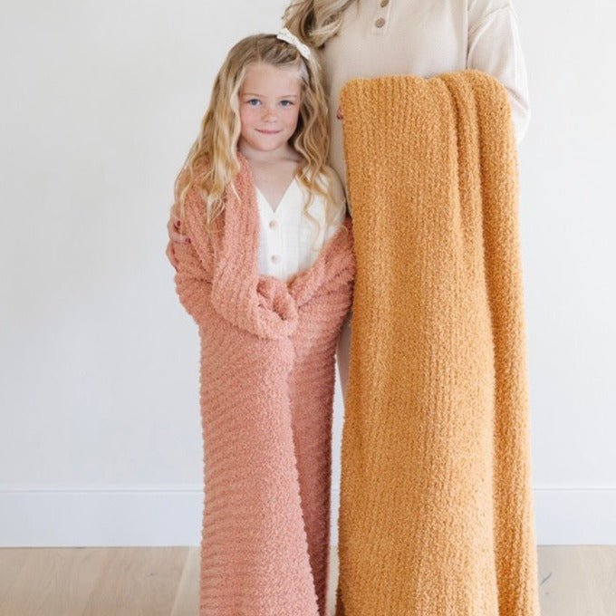 Ribbed Bamboni® toddler blankets in soft colors, perfect for cozy bedding and sleep for little ones.