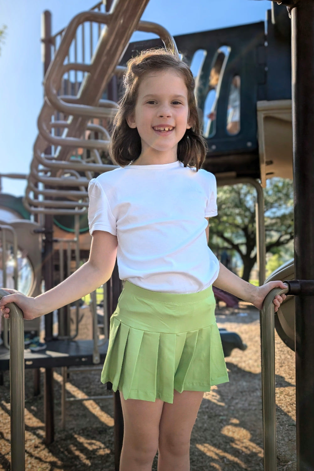 PLAY+ Girls Millie Tennis Skirt in vibrant colors, perfect for active play and stylish outings.