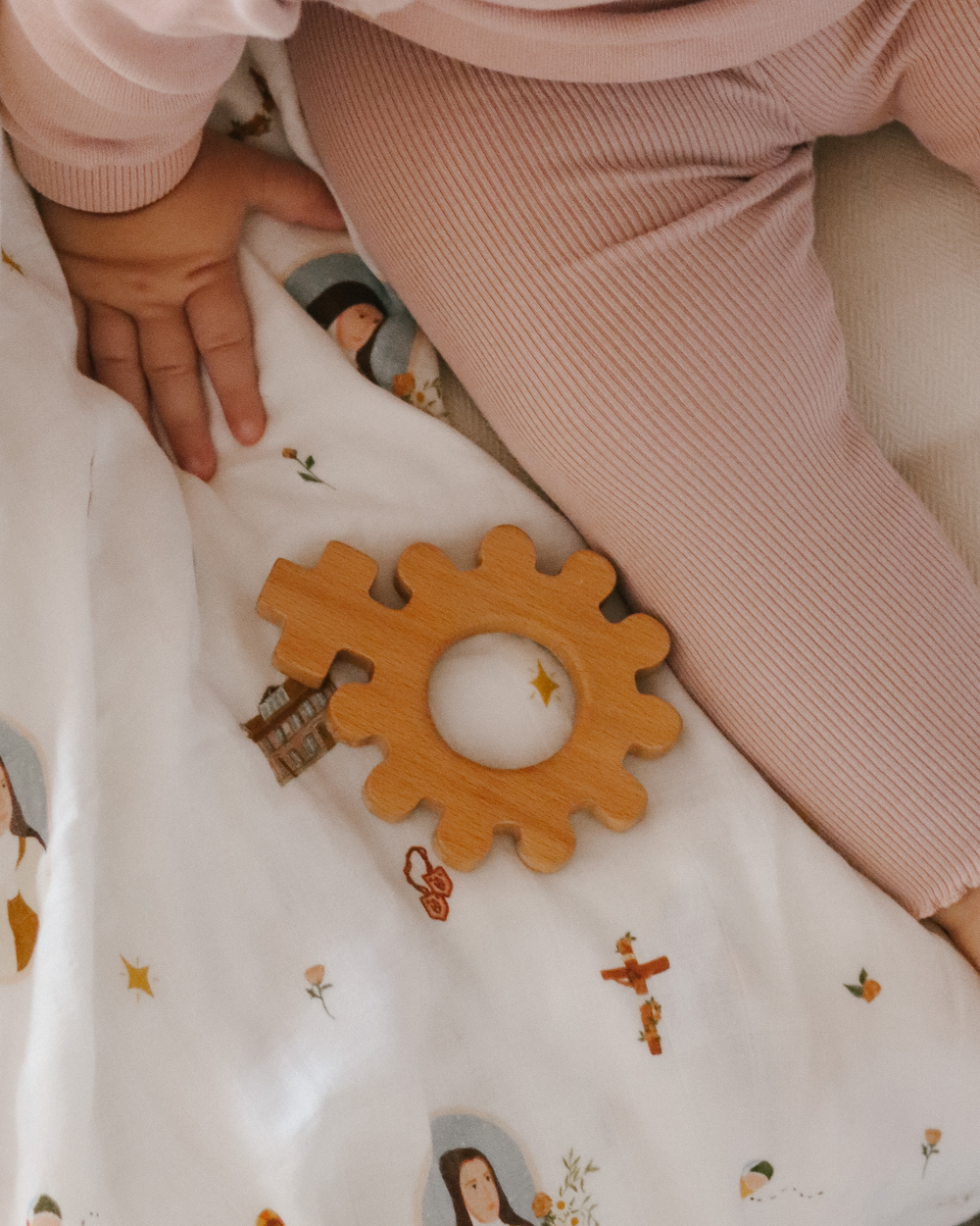 "Baby's First Rosary Wooden Teether - safe, natural, and perfect for soothing gums during teething."