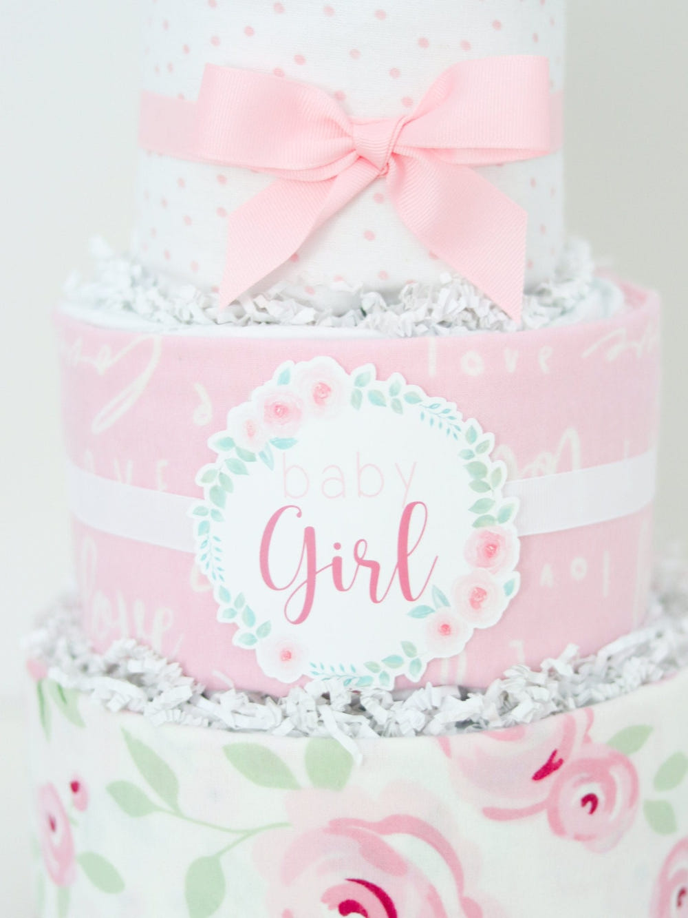 Rose Diaper Cake: Adorable and unique baby shower gift made of diapers, decorated with pink roses and ribbons.