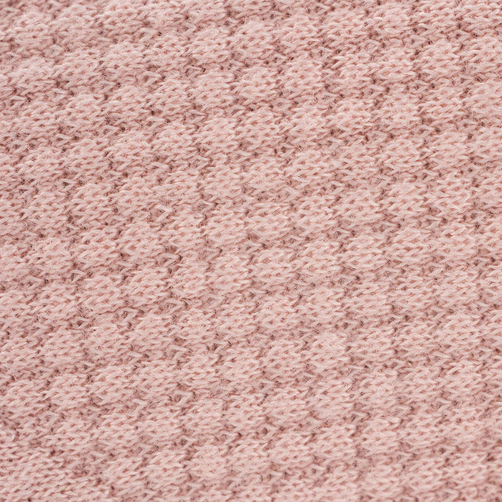 Soft rose knit blanket for babies, perfect for cozying up and keeping warm. Ideal for nurseries and baby gifts.