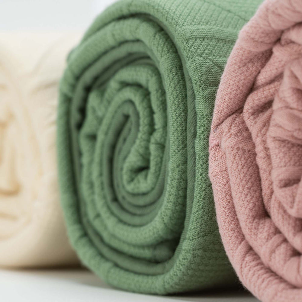 Soft sage knit baby blanket, perfect for cozying up your little one.