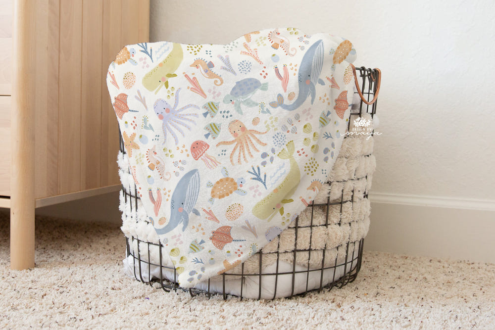 Vintage baby blanket featuring adorable baby animals and the alphabet, perfect for nursery decor and cozy comfort.