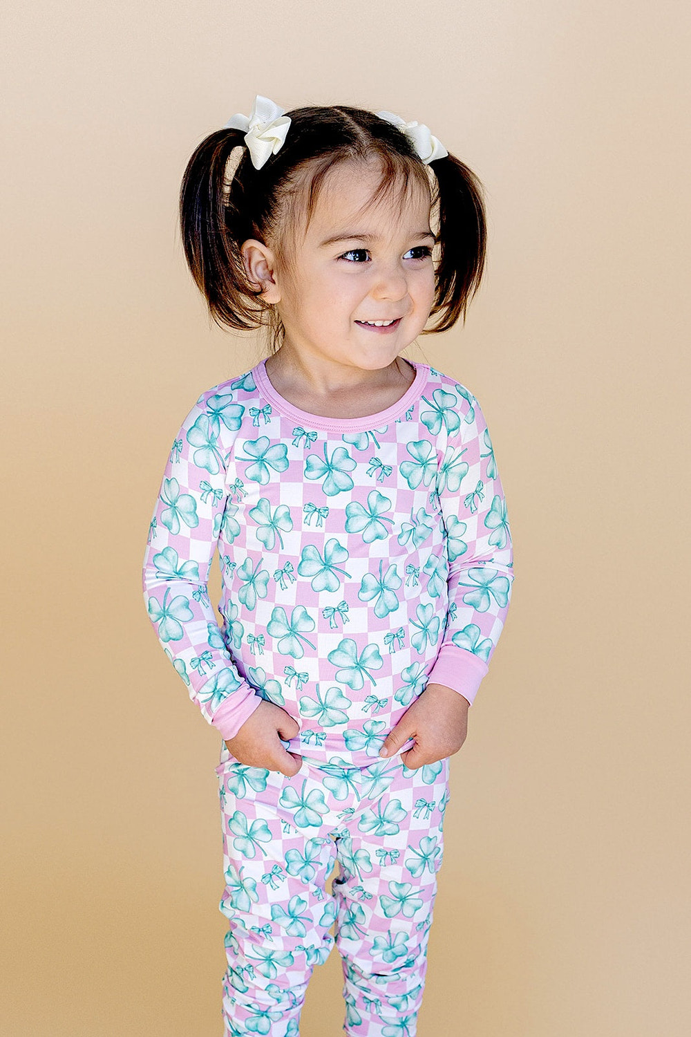 Bamboo two-piece romper set in shamrock and bows design for babies. Soft, eco-friendly, and stylish outfit.