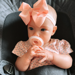 mōmi babypace® breast-like pacifier in multiple vibrant colors