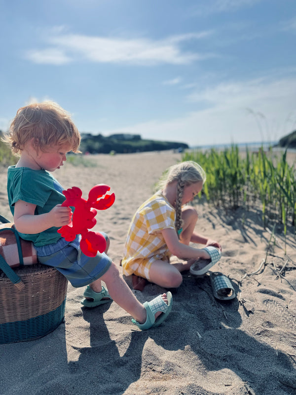 Fern plaid slide sandals for babies, showcasing a stylish design from an angled view. Perfect summer footwear!
