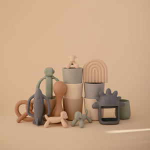 Lamb figurine teether for babies, soft and safe for soothing gums, angle view showcasing its cute design.