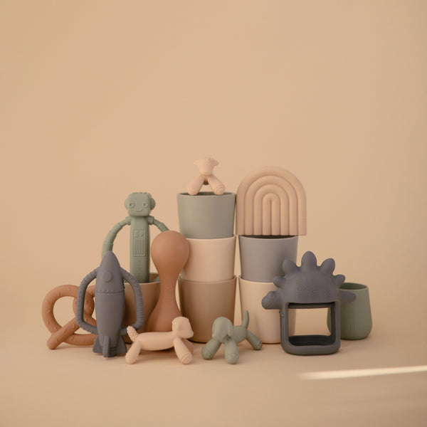 Lamb figurine teether for babies, soft and safe for soothing gums, angle view showcasing its cute design.
