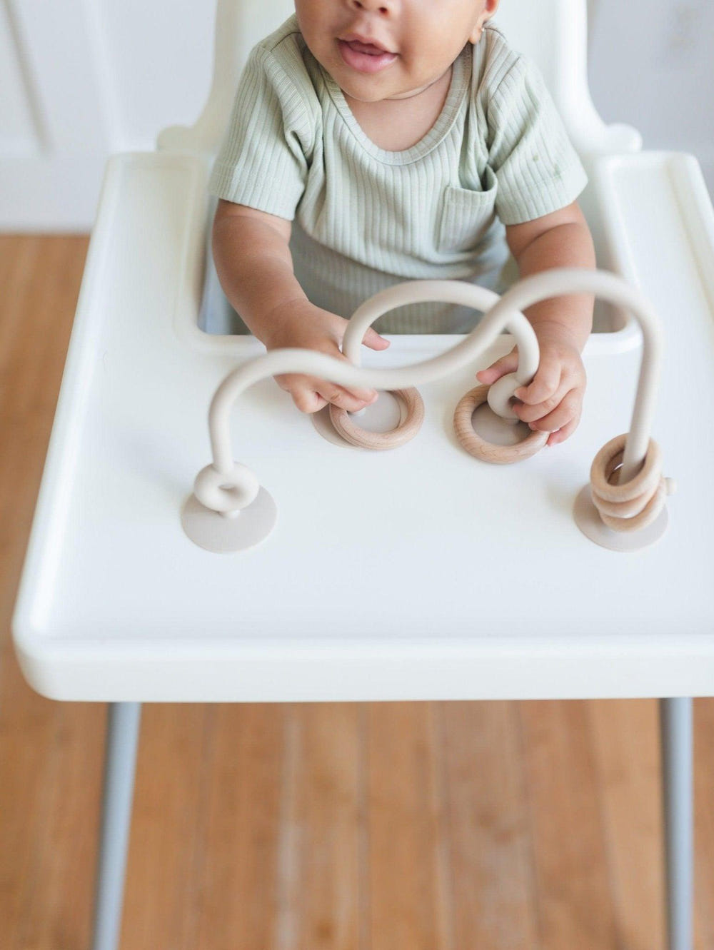 Silicone highchair toy in various colors, perfect for engaging babies during mealtime.