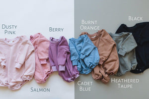 "Sunday Funday Football Sweatshirt Romper in various colors, angle view showcasing cozy baby apparel."