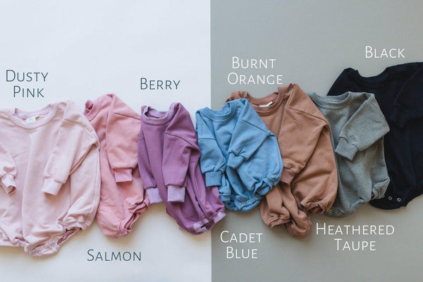 "Sunday Funday Football Sweatshirt Romper in various colors, angle view showcasing cozy baby apparel."