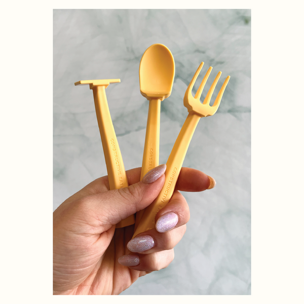 Colorful baby training utensils for easy self-feeding, designed for little hands.