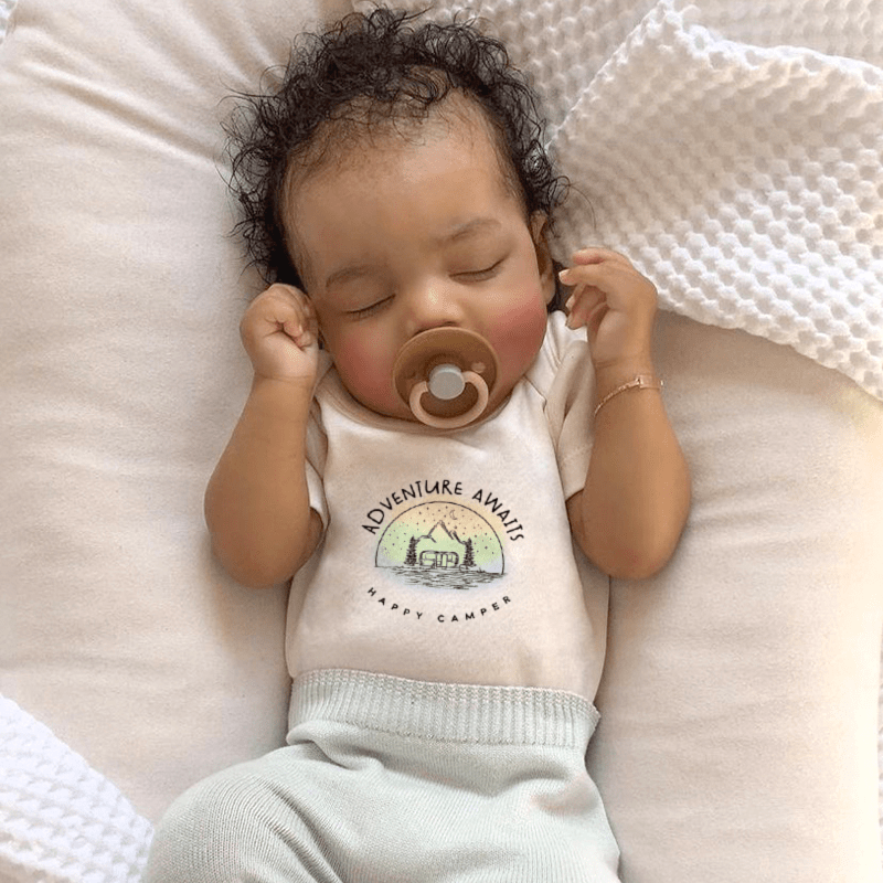Graphic bodysuit for babies with "Adventure Awaits" design, perfect for playful outings. Short sleeve comfort.