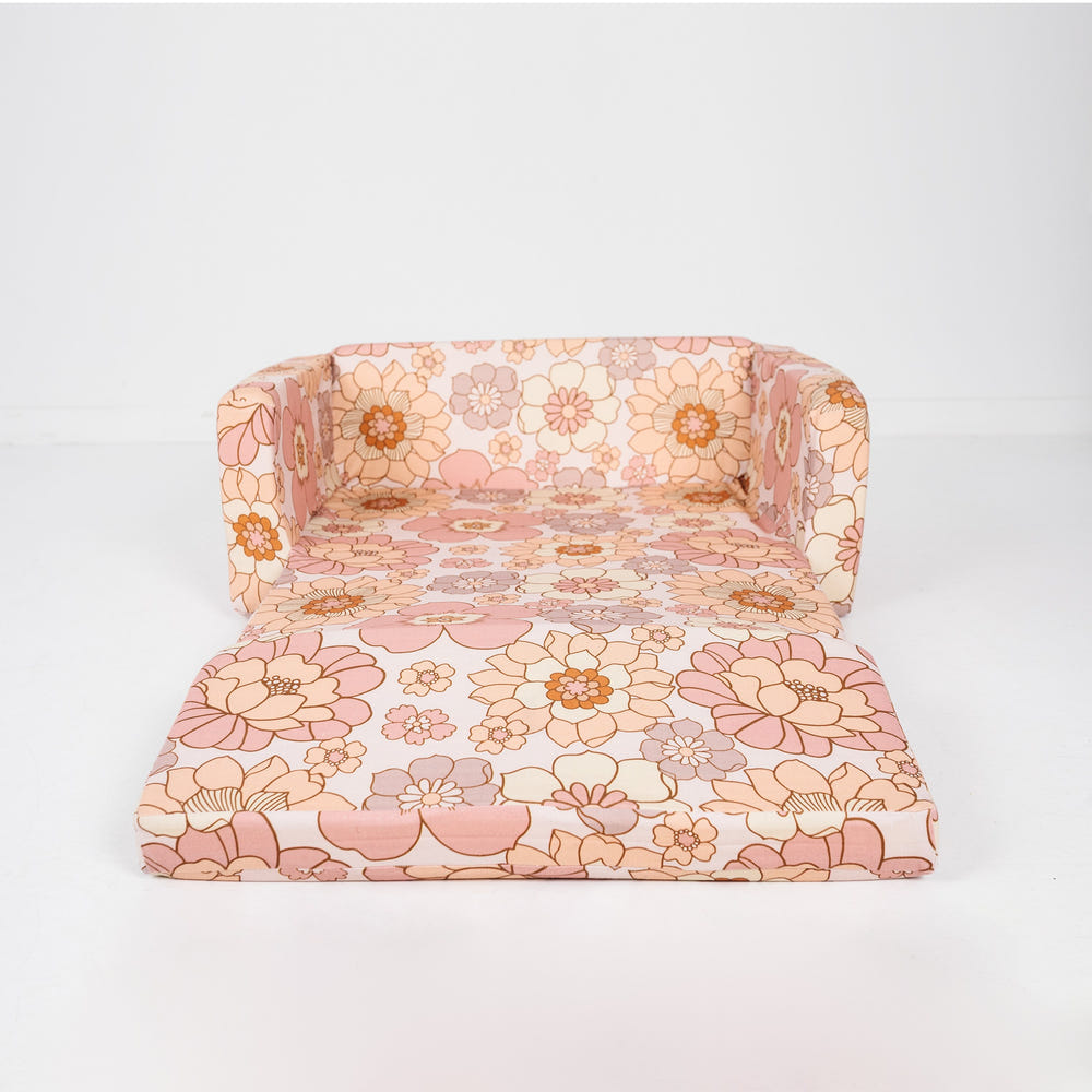 "Blooms Play Couch in vibrant colors, perfect for imaginative play and cozy lounging for babies and toddlers."
