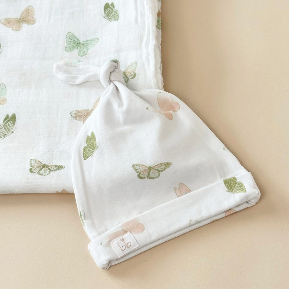 Top Knot Hat featuring a butterfly design, perfect for stylish baby outfits.