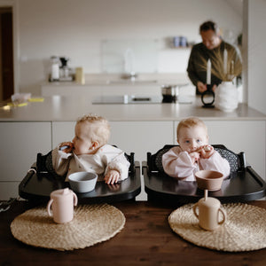 Silicone training cup with straw at a 25-degree angle, perfect for toddlers learning to drink independently.