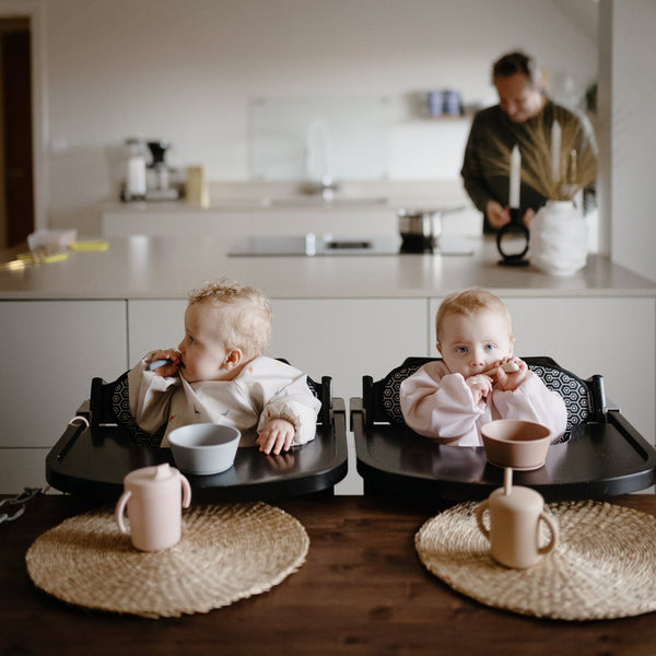 Silicone training cup with straw at a 25-degree angle, perfect for toddlers learning to drink independently.