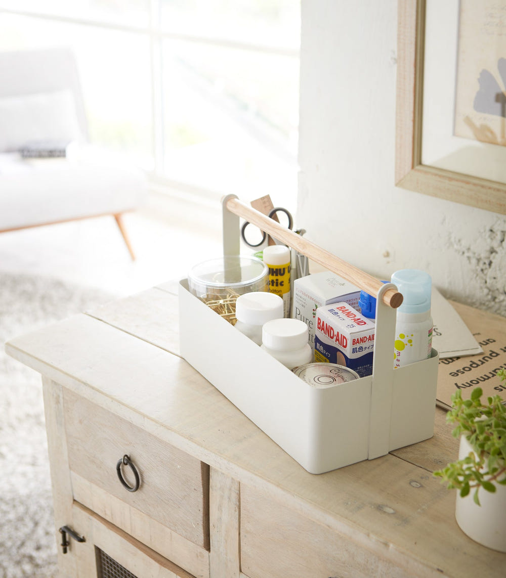Large steel and wood storage caddy for organizing baby essentials on a desk.