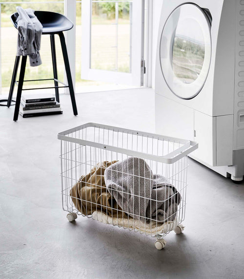 Rolling wire laundry basket in steel, 14.8" H, perfect for organizing baby clothes and essentials.