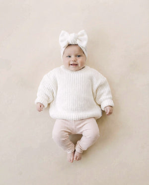Chunky knit baby sweater in milk color, showcasing cozy texture and stylish design from angle 3.