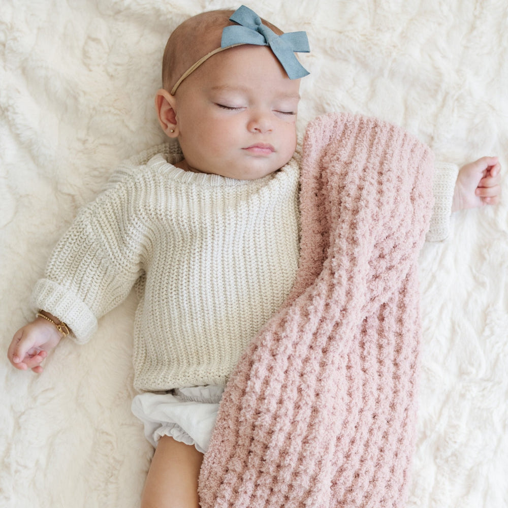 Waffle knit mini blankets for babies in soft, cozy fabric, perfect for swaddling and keeping little ones warm.
