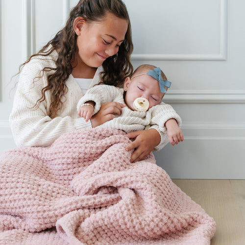 Waffle knit receiving blankets in soft colors, perfect for swaddling and keeping your baby cozy.
