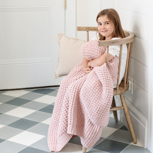 Waffle knit toddler blanket in soft colors, perfect for cozying up or swaddling your little one.